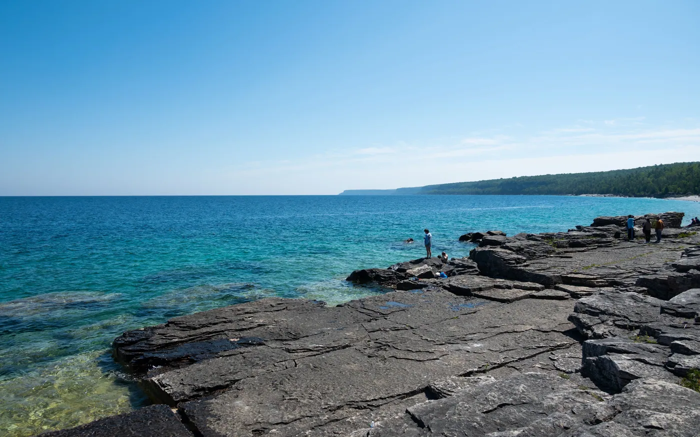 A flat rock shelf running out into clear shallow water