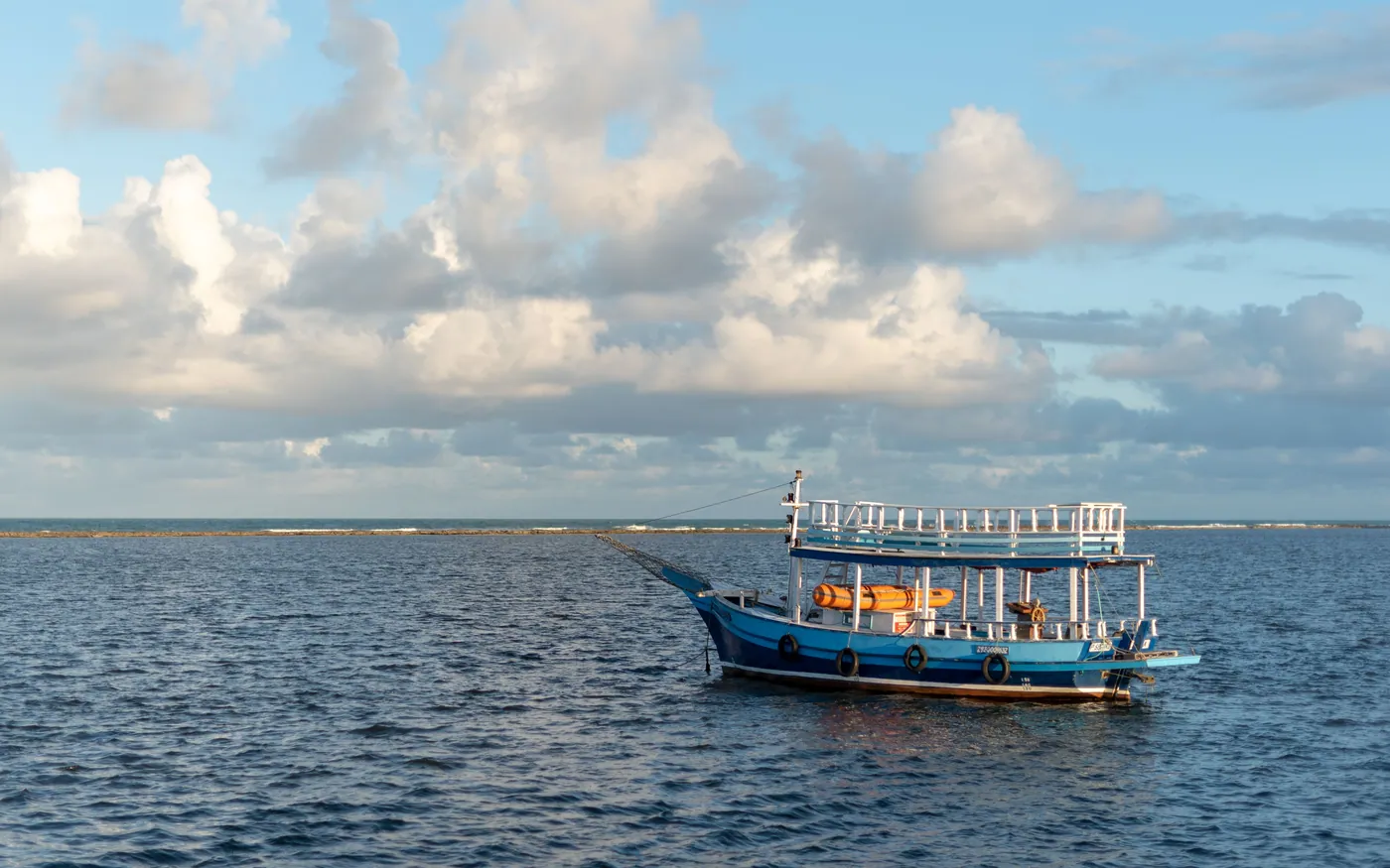 A boat at a quiet mooring under a cloudy sky