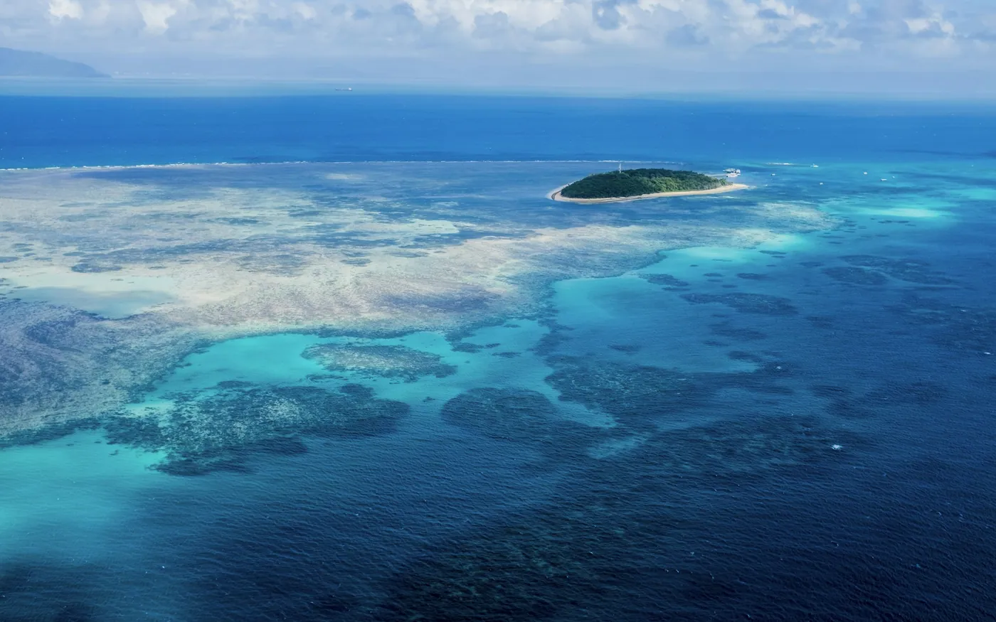 A shallow reef and small island photographed from above