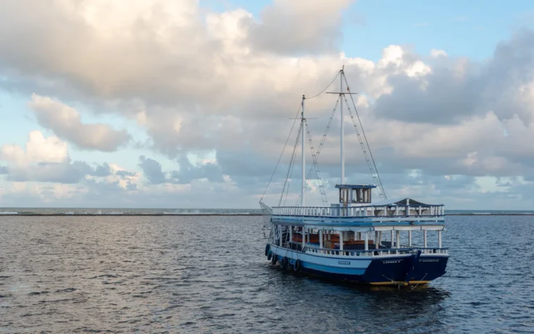A small open boat anchored off a sandbar