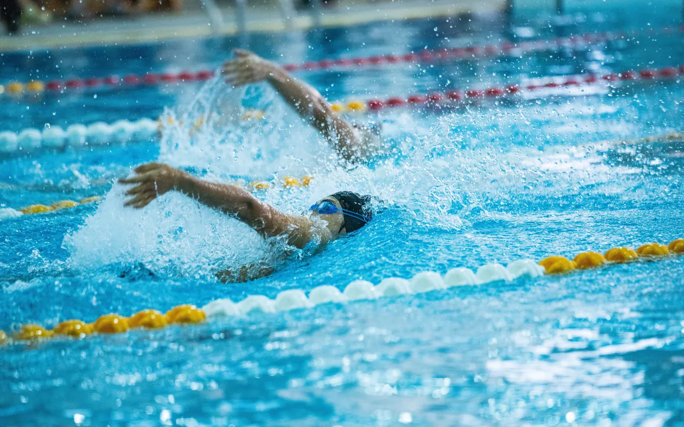 A swimmer holding an even rhythm in a marked lane