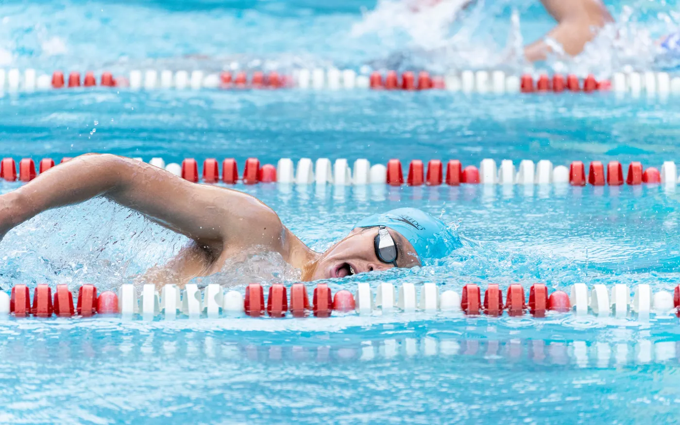 A swimmer part way along another length of the pool