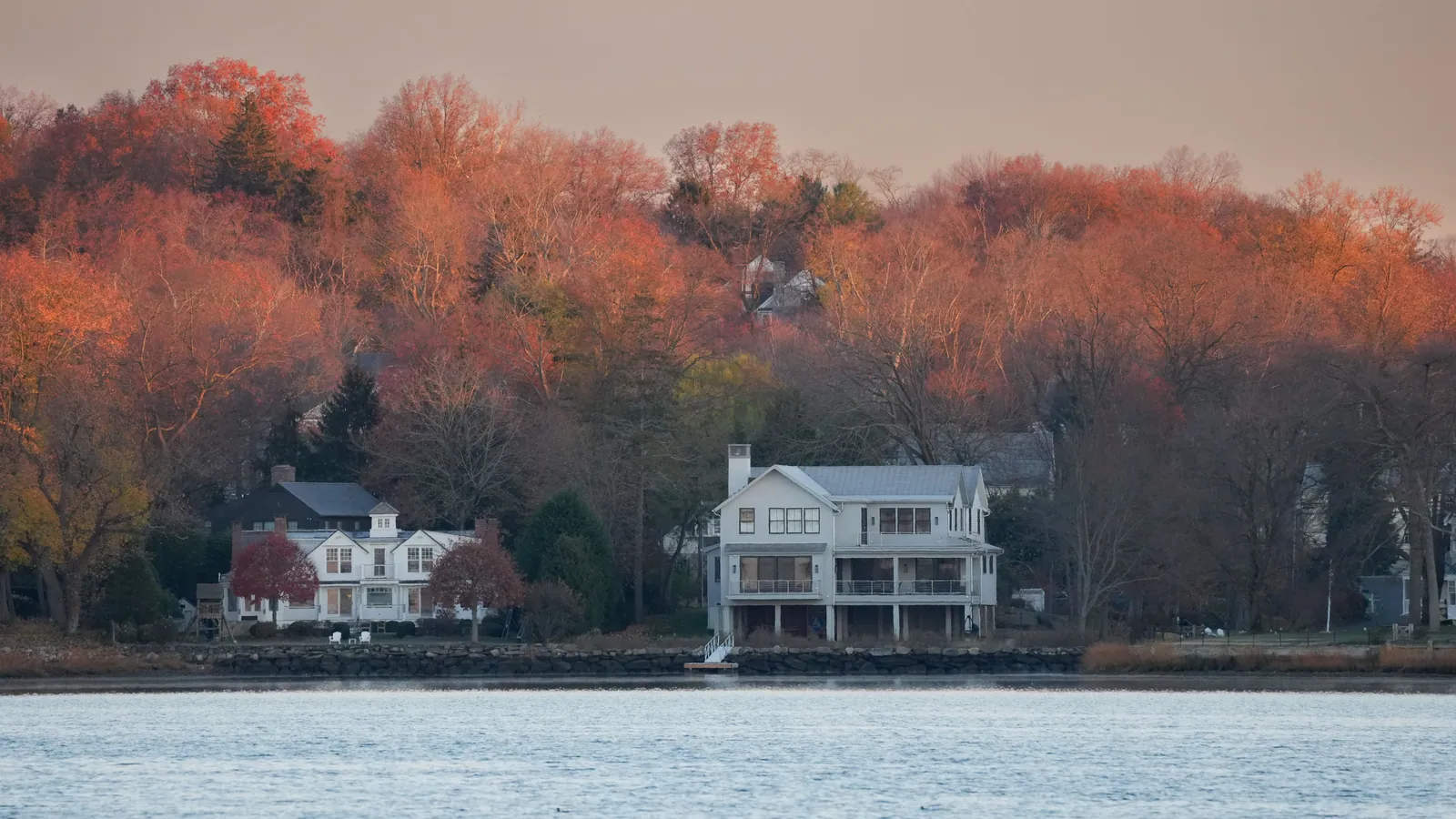 A New England shoreline under autumn foliage