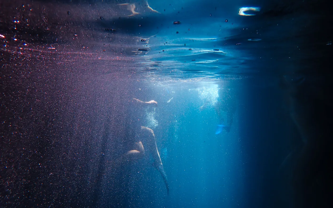 Dark water below the surface where colors have already gone