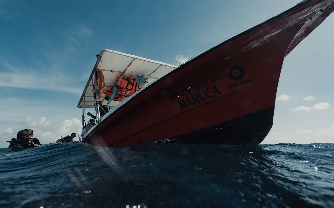 The bow of a dive boat underway with gear stowed on deck