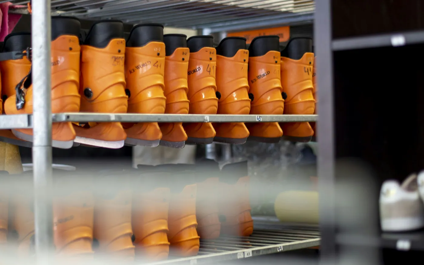 Rows of dive boots racked on shelves for storage
