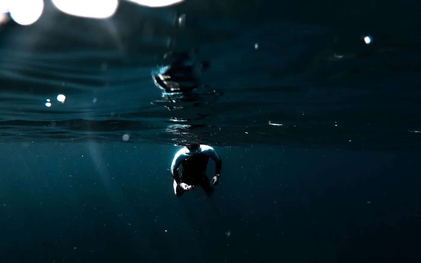 A diver at the surface in dark water after a dive