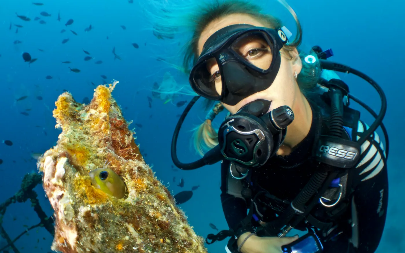 Close-up of a scuba diver breathing through a regulator underwater