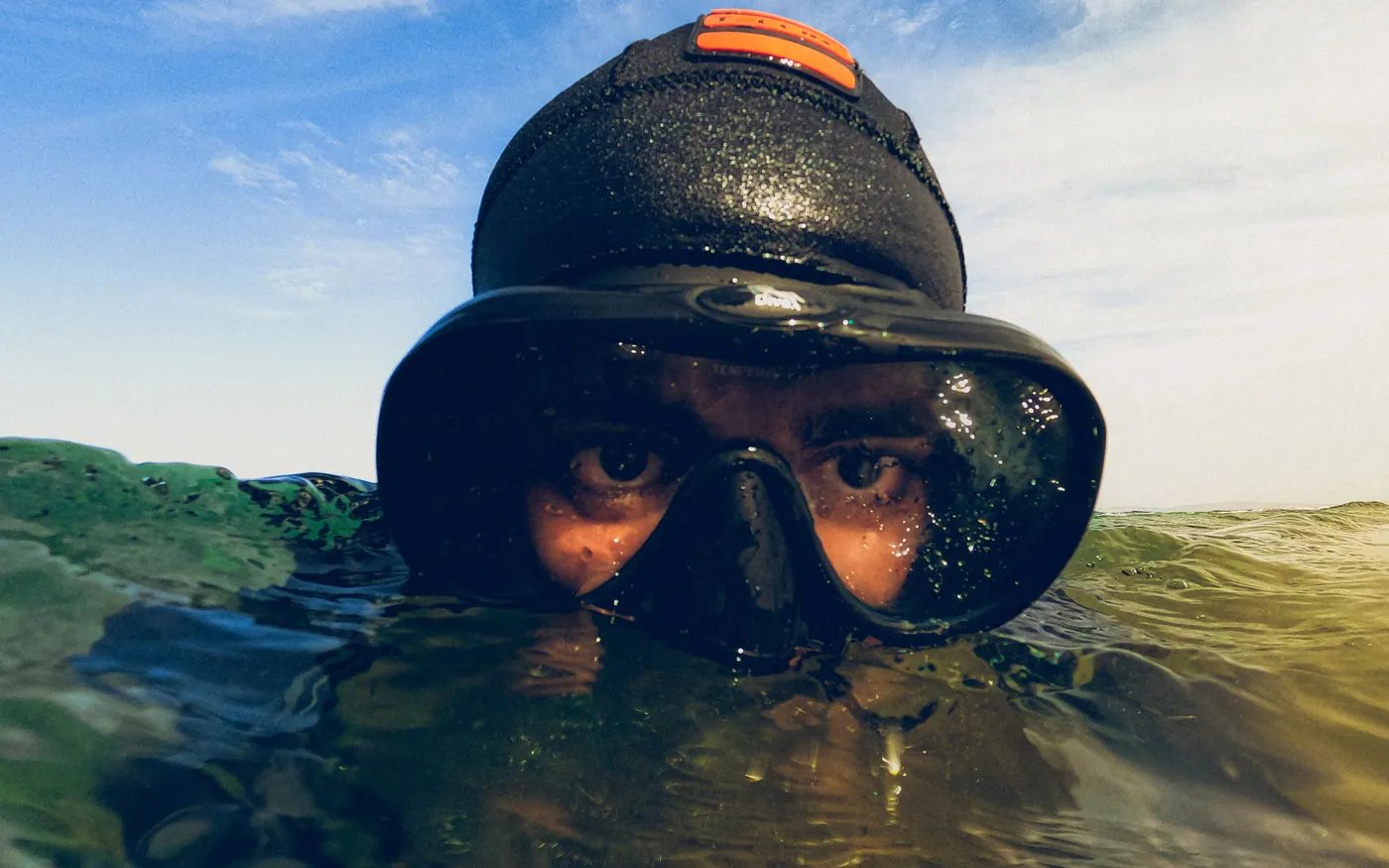 Close-up of a diver's eyes through a mask at the surface