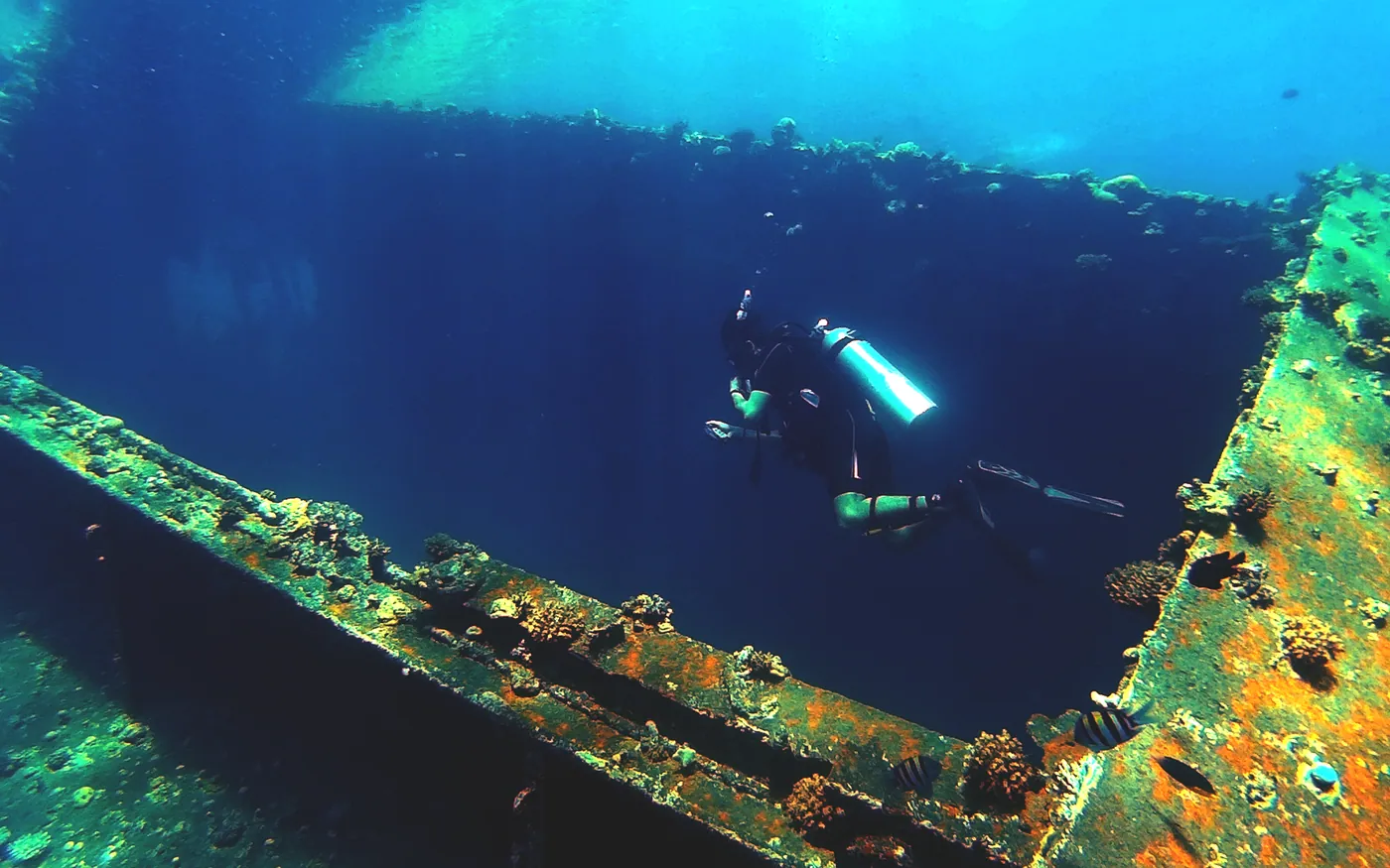 A diver using a wreck as a navigational edge to follow