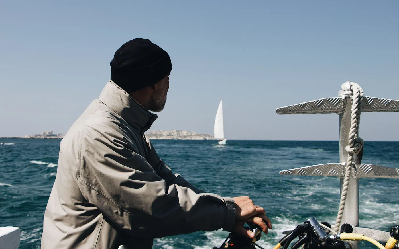 A diver checking equipment on a boat before a dive