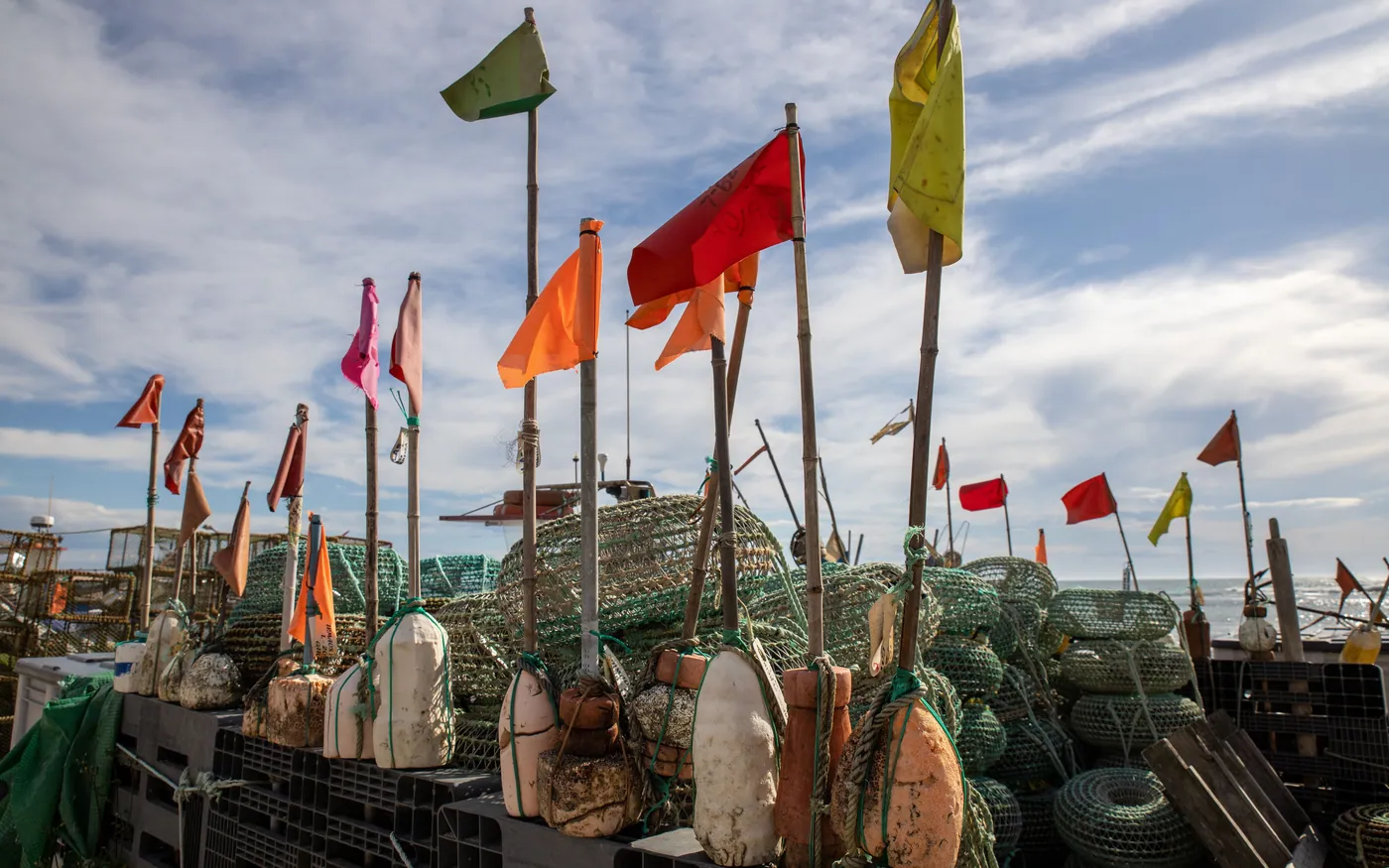 Fishing gear and marker flags stacked on a working dock