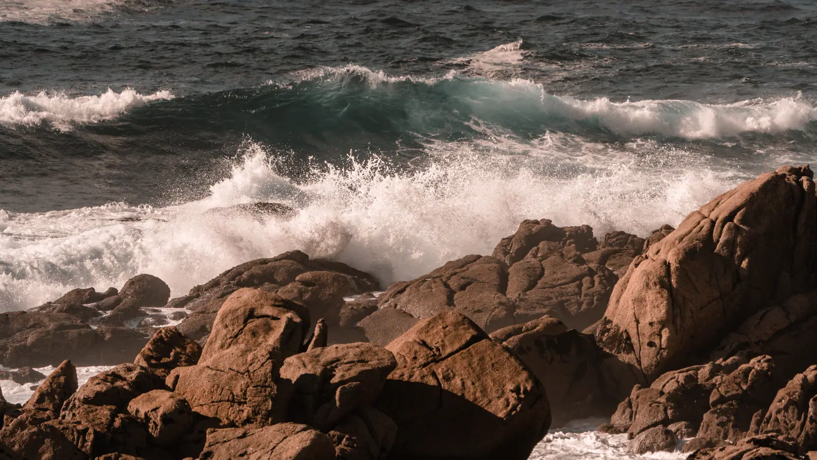 Heavy surf breaking against a rocky shoreline