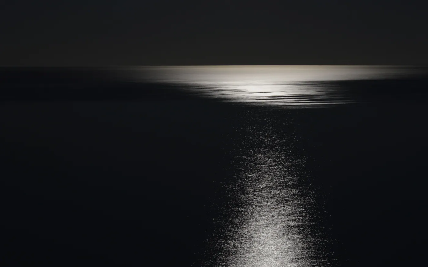 Moonlight tracking across dark open water