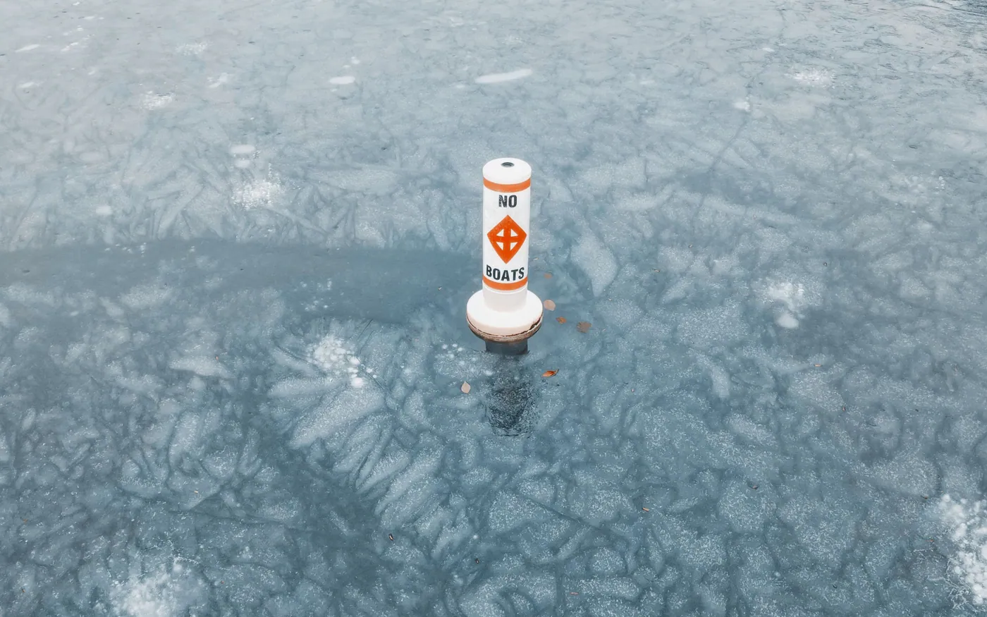A navigation marker buoy standing in cold, choppy water