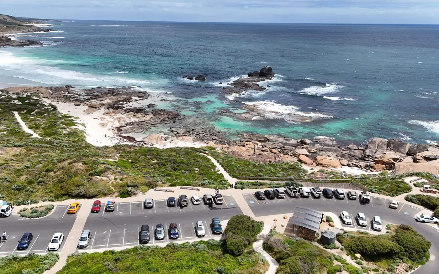A parking area on the headland above a rocky bay