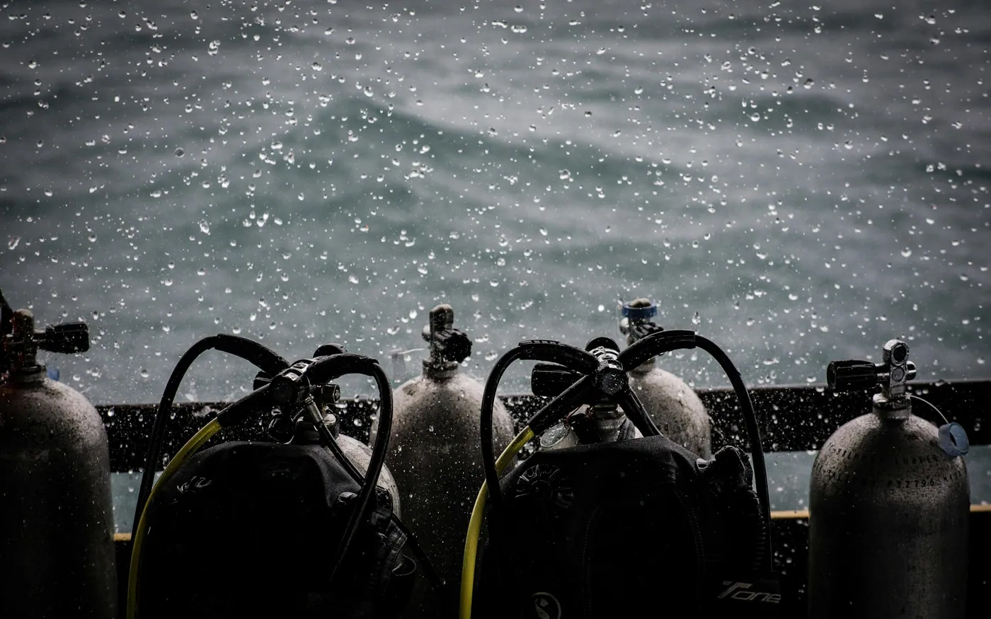 Scuba cylinders standing upright and secured in a rack