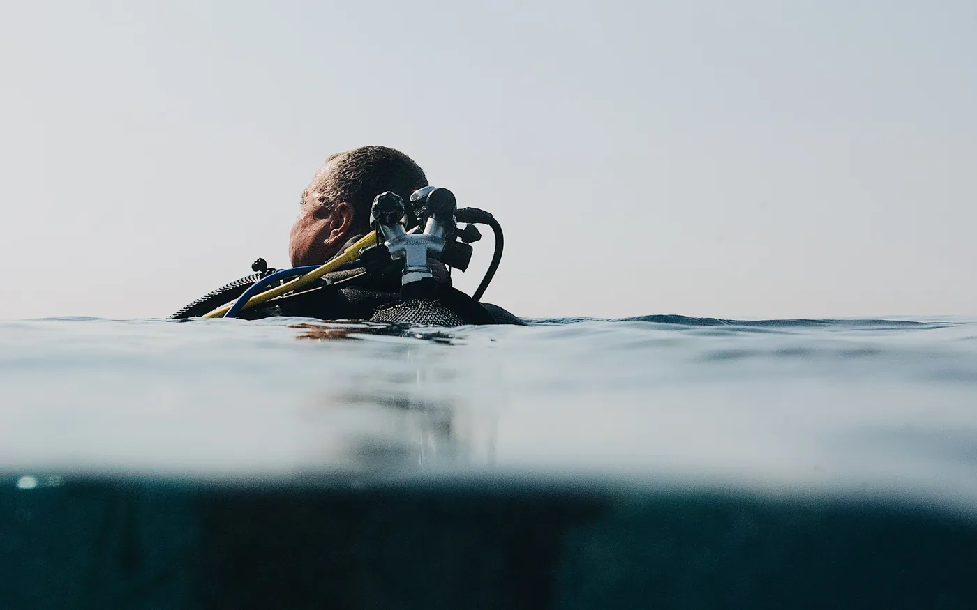 A scuba diver at the surface in full gear