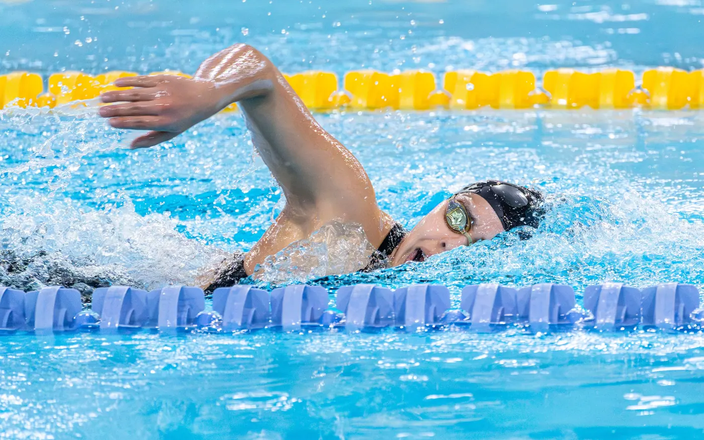 A swimmer working steadily along a pool lane