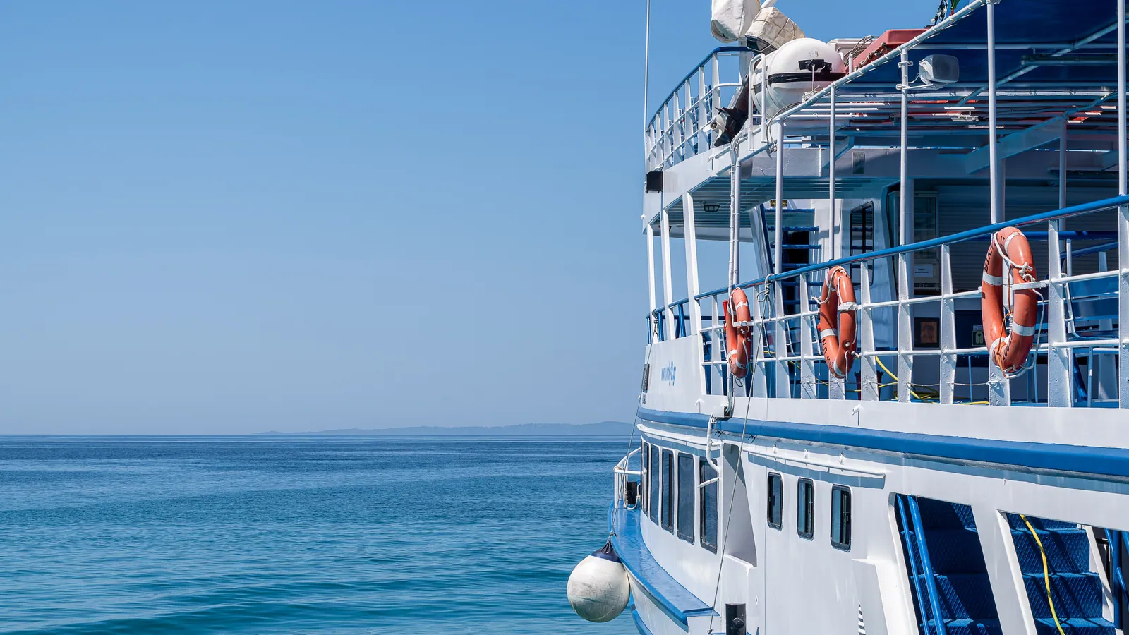 The side deck of a dive boat with liferings along the rail