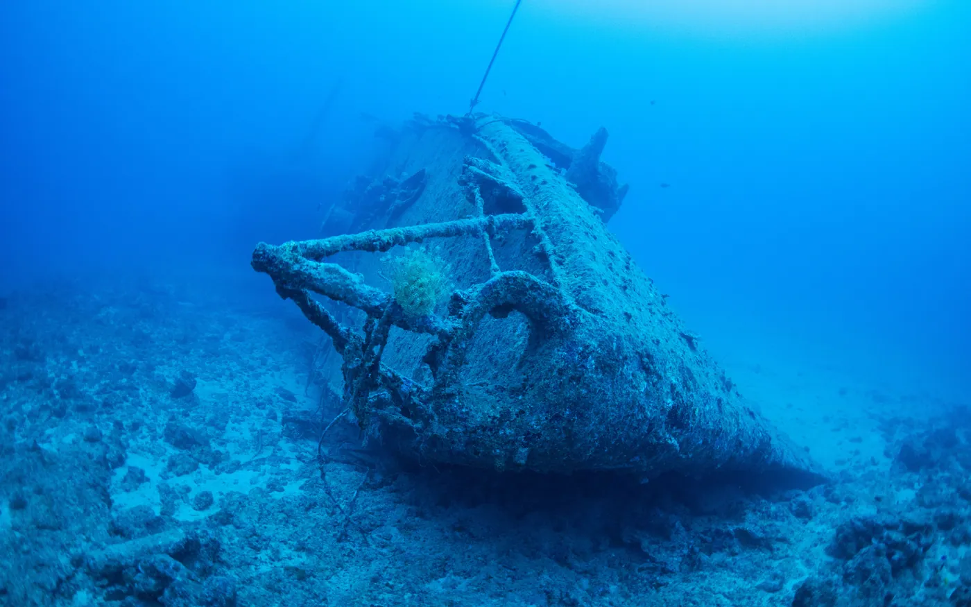 A wreck lying in open blue water